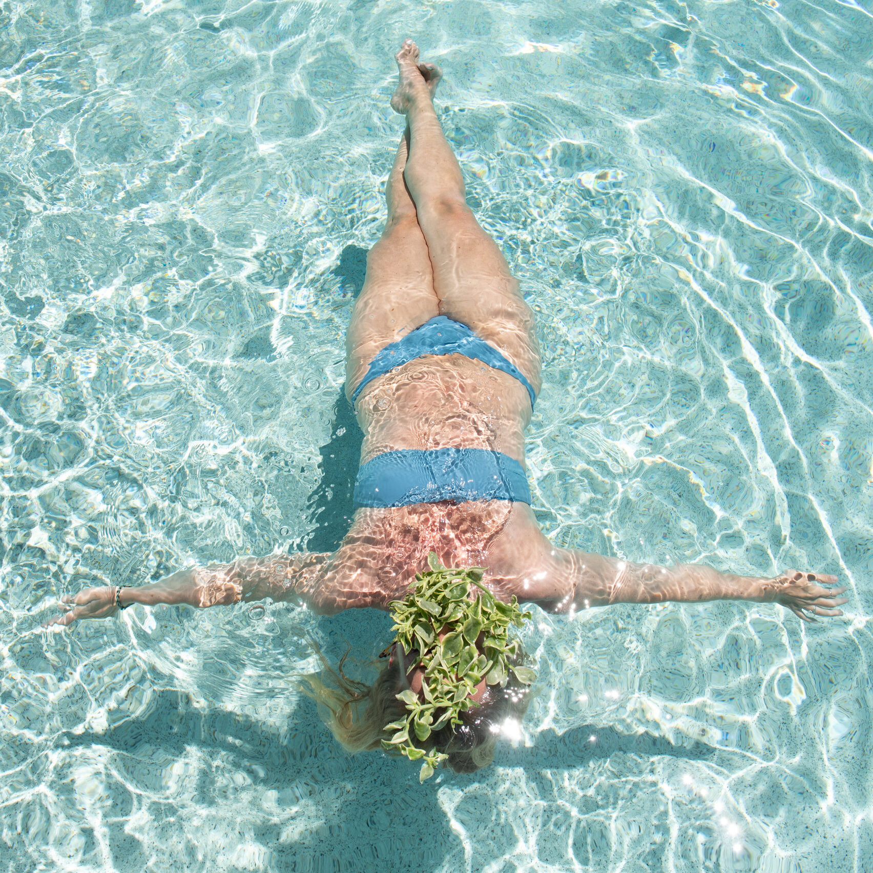 A woman floating in the pool